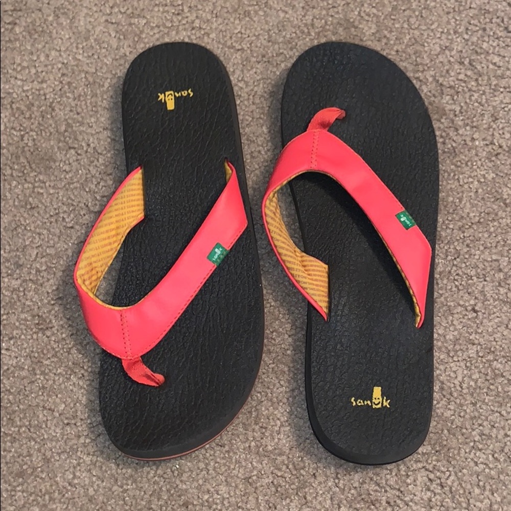 Lightly used sanuk orange flip flops